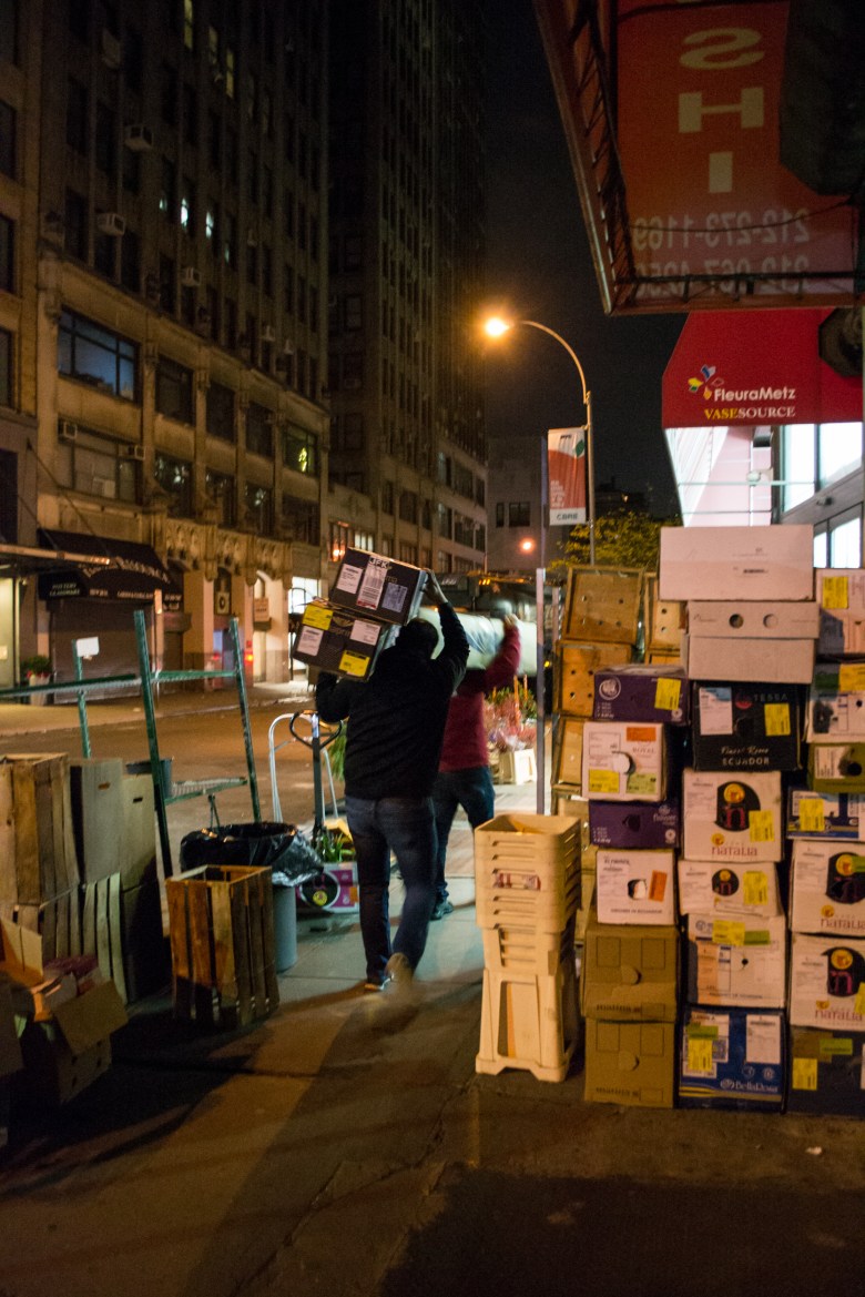 Boxes of flowers are carried down 28th Street.